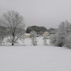 schneebedeckte Tallage des Ortsteiles mit zwei Häusern