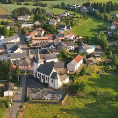 Luftbildaufnahme von Seinsfeld aus dem Jahre 2020 - im Vordergrund die Kirche und eingefügtes Gemeindewappen