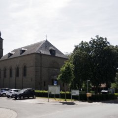 Neoklassizistischer Bruchsteinbau aus gelben Sandsteinen mit fünf halbkreisförmig schließenden Fenstern und Turm